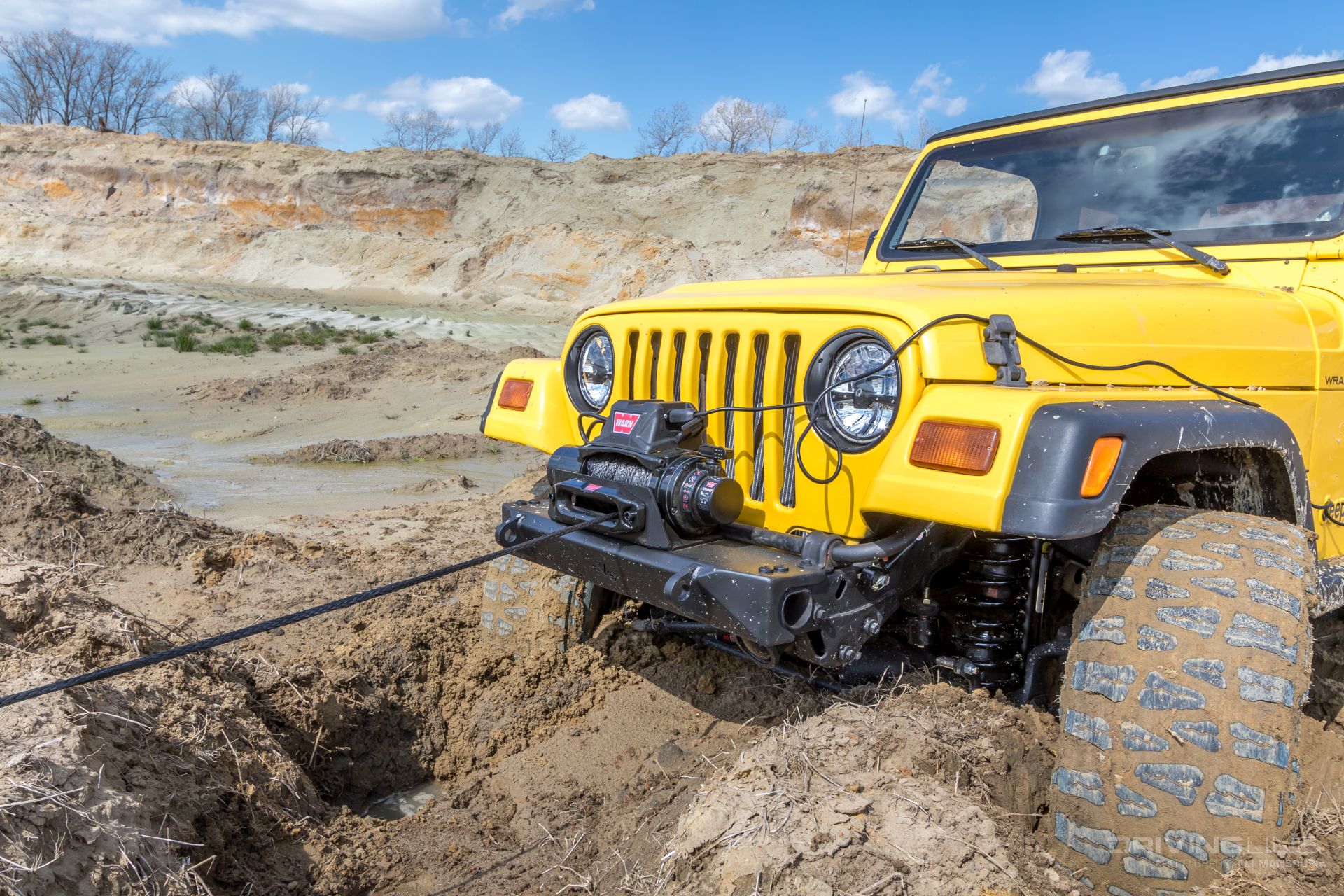 2023 Winch Buyers Guide: yellowjeep with bumper mounted warn winch