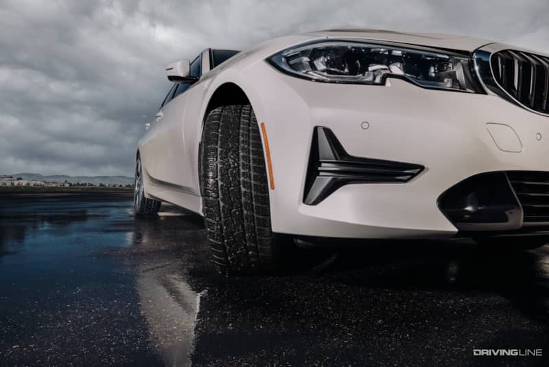 Tread face of Nitto Motivo 365 all season tire in wet conditions on luxury car