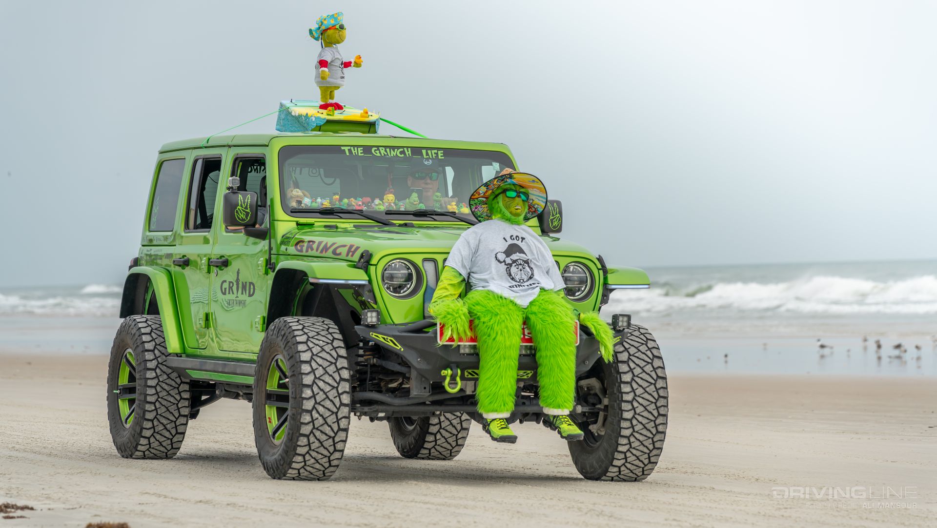 Grinch Themed Green Jeep Wrangler JL driving on Daytona Beach shoreline